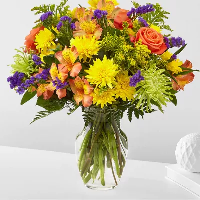 Flowers of yellow and green, and pops of orange and purple. Full of color and texture, all you need is love and our Marmalade Skies Bouquet.