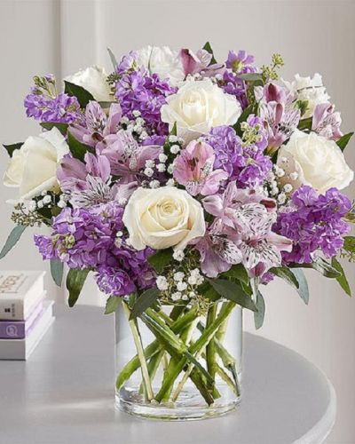 <p>Lovely memories are made with thoughtful gifts for the ones we care about. Our charming bouquet is loosely gathered with a medley of lavender & white blooms. Hand-designed inside a clear cylinder vase with cascading greenery all around, it’s a wonderful way to express the sentiments you have inside your heart.</p>